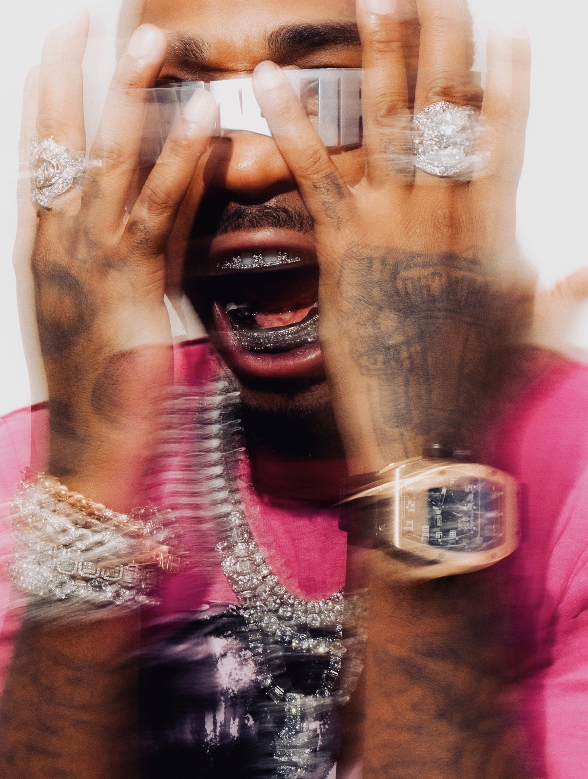 Quavo wearing chrome QRÖMELIFE eyewear, framed by hands and jewelry
